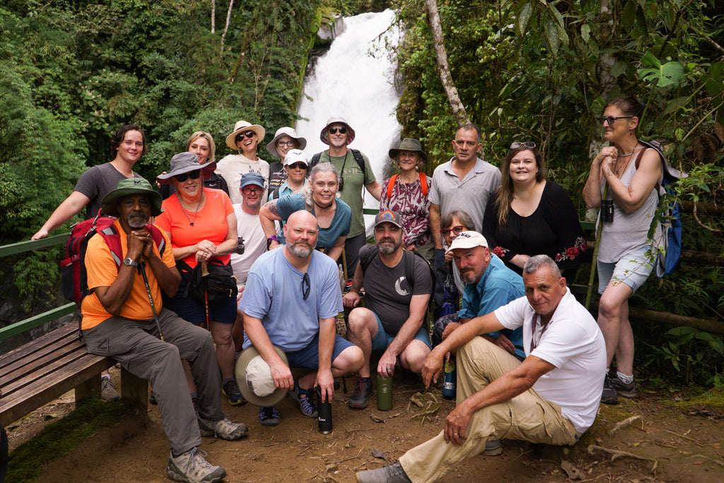 A group of hikers in front of a waterfall in Costa Rica