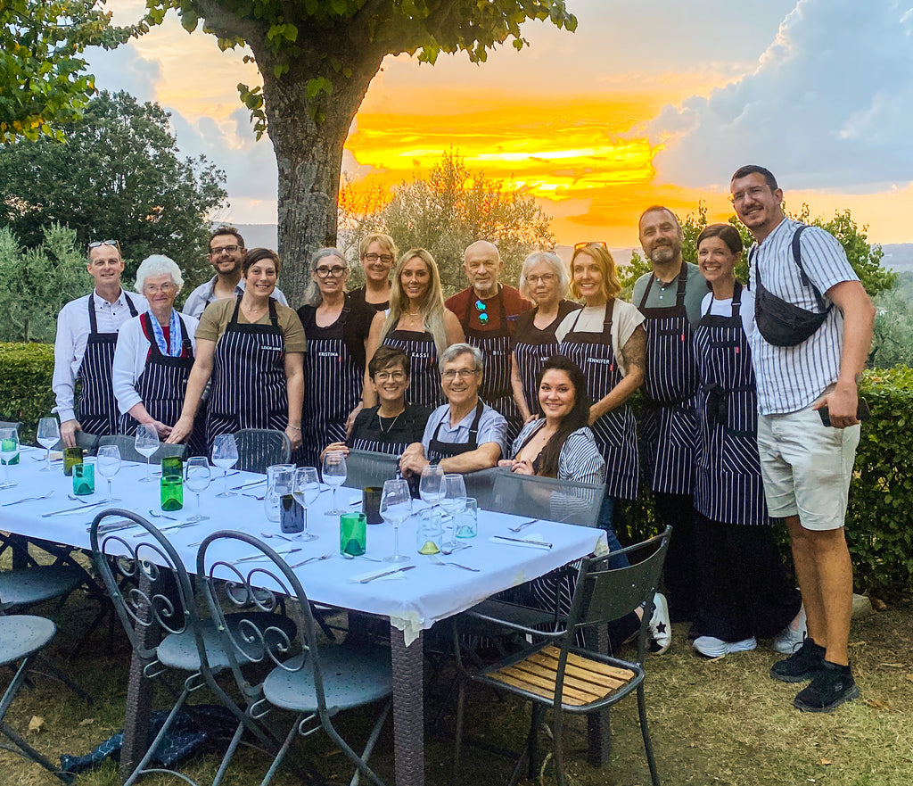Group of culinary students in aprons at sunset in Italy