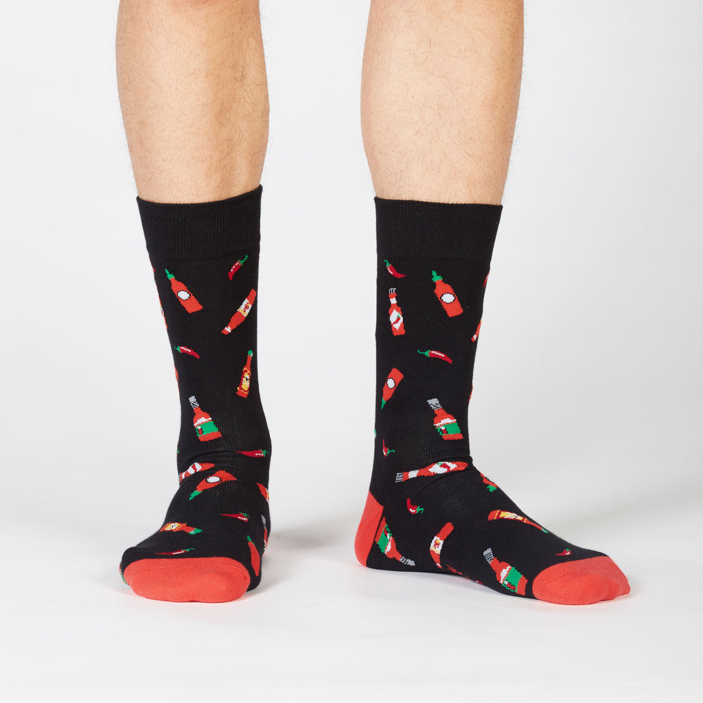 two legs and feet wearing hot sauce socks